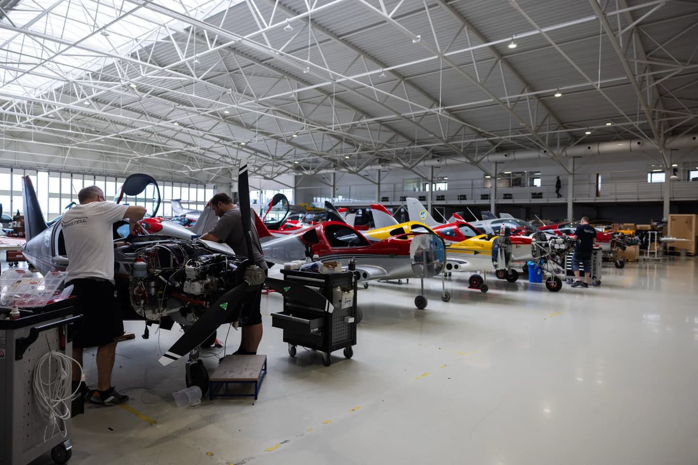 The Bristell production floor in Kunovice, with technicians working on aircraft in final assembly