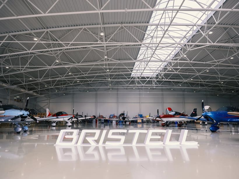 Bristell aircraft lined up inside the hangar in Kunovice, with a large Bristell sign on the floor, 2026