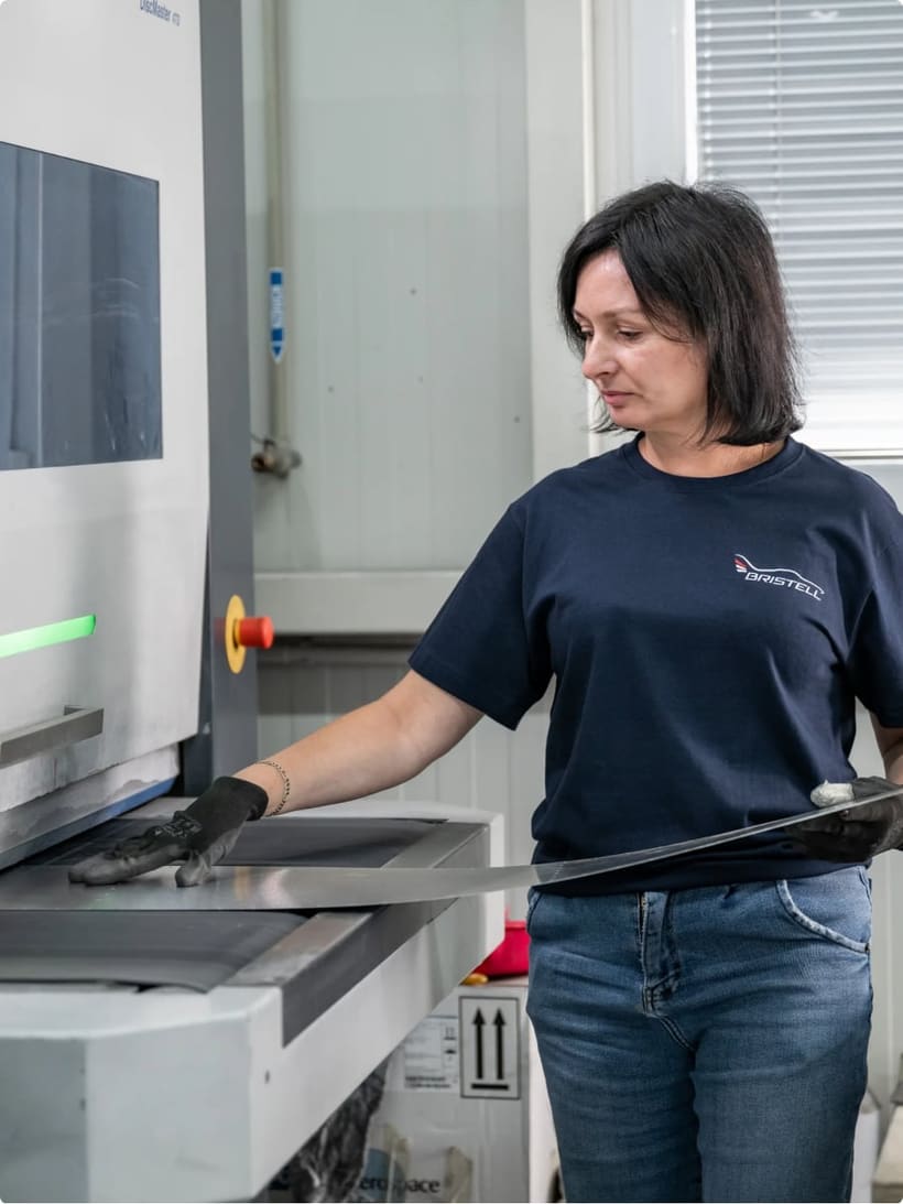 Bristell team member finishing a sheet-metal component on the production line