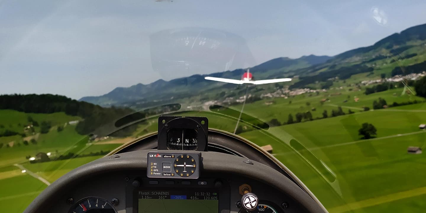 A Bristell aircraft towing a glider aloft at Aero-Club Schänis in the Swiss Alps