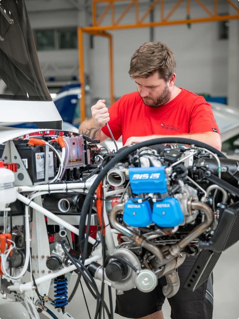 Bristell technician installing a Rotax 915 iS engine during final assembly