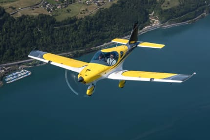Bristell B23M in flight over a lake