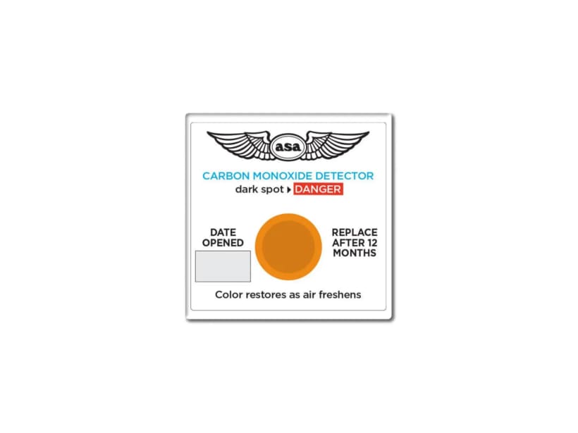 Cockpit-mounted carbon monoxide detector card whose spot darkens when CO is present.